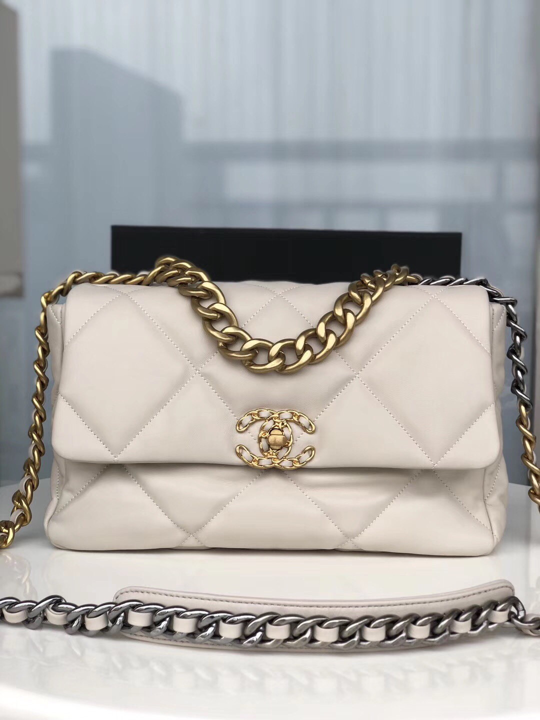 Ch*el 19 large handbag shiny leather, gold-tone, silver-tone & ruthenium-finish metal beige 7.8 × 11.7 × 3.9 in